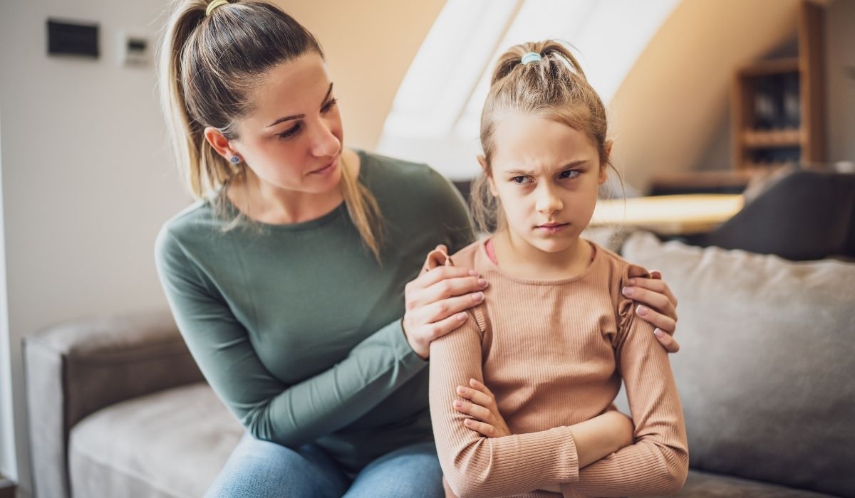 Parent sitting with a young child in a calm moment at home